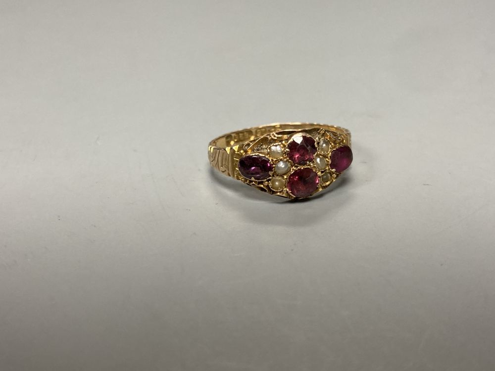 A Victorian 15ct gold, garnet and seed pearl cluster dress ring, size N, gross 1.8 grams, another ring and a bar brooch.